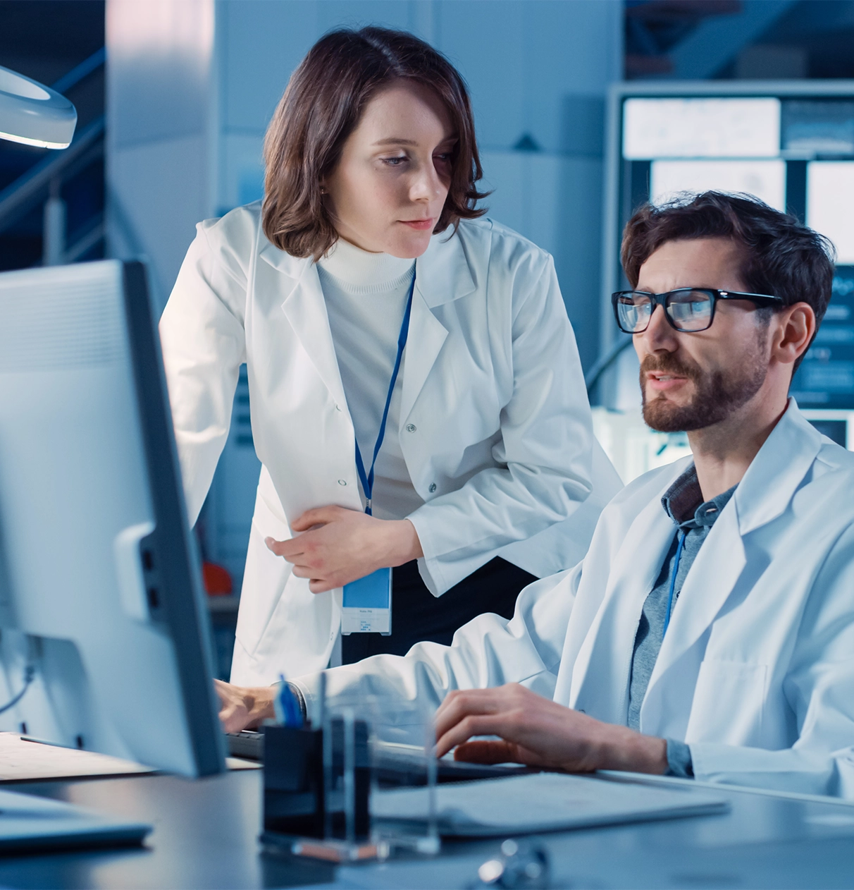 Two lab techs working on a computer