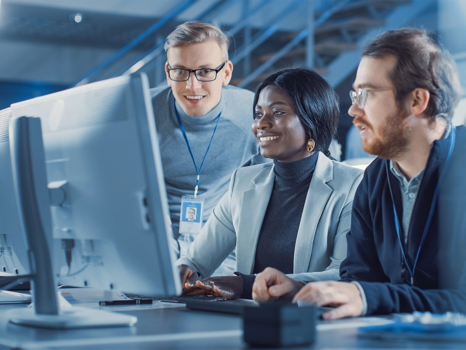 A team of lab techs on a computer